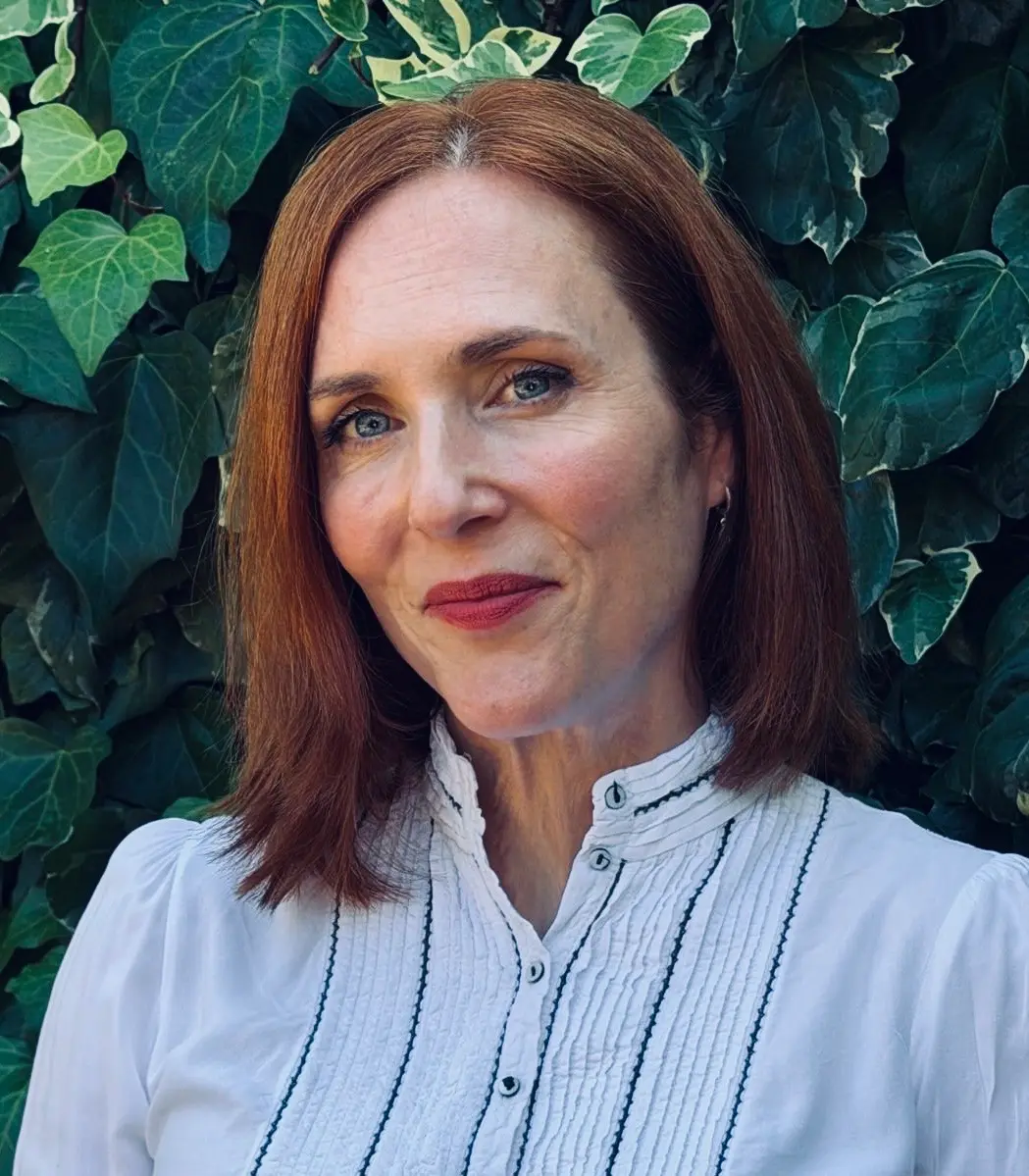 28690a13-c283-4c32-848f-0ecc92369465 Portrait of psychotherapist Lucy Clyde smiling at the camera.